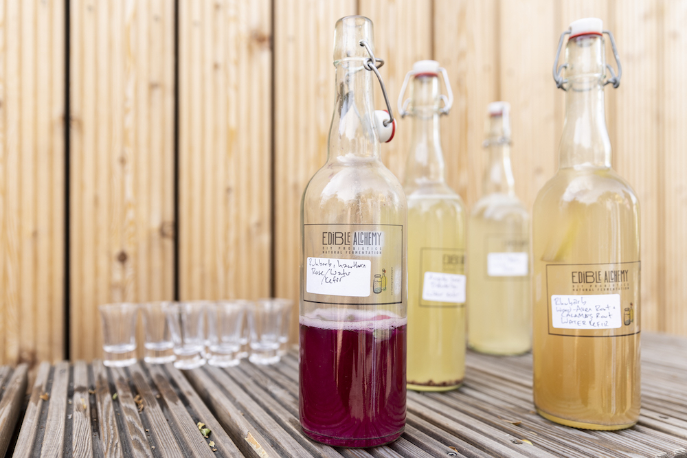 bottled edible alchemy water kefirs on table