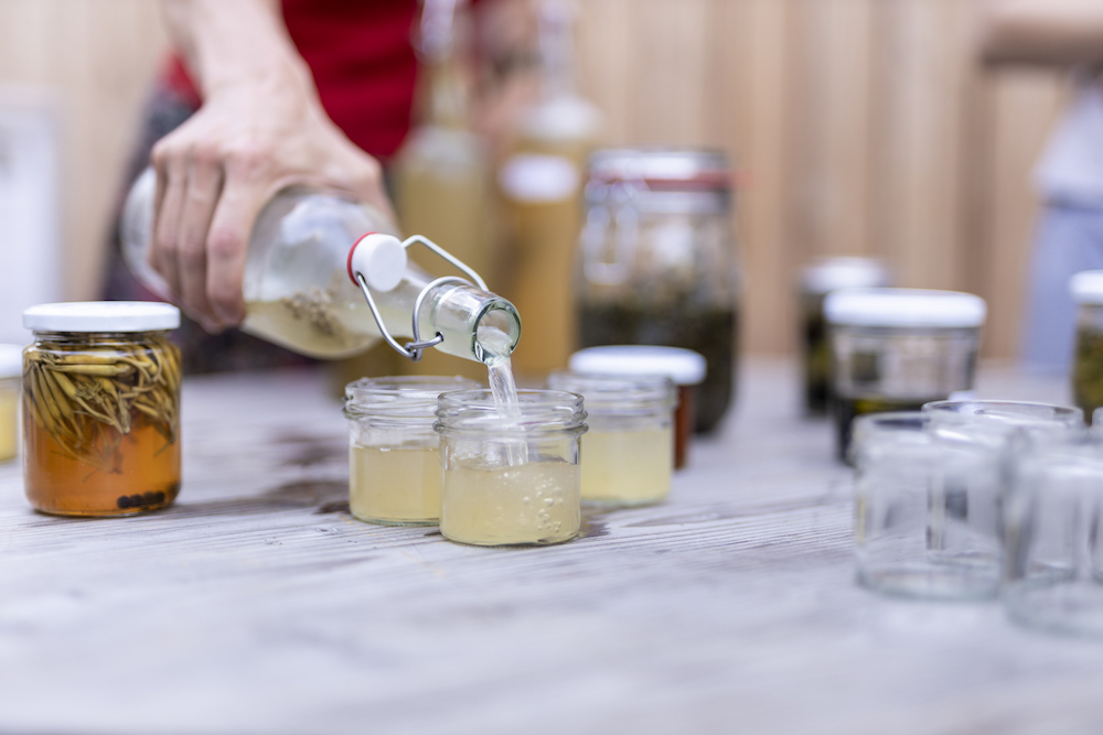 pouring edible alchemy water kefir drinks