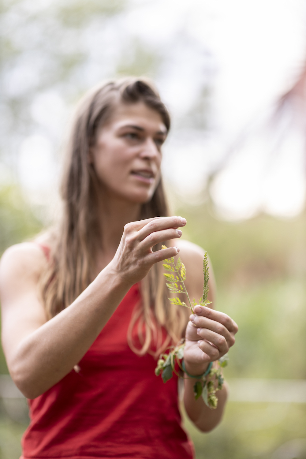 alexis holding up foraged plants